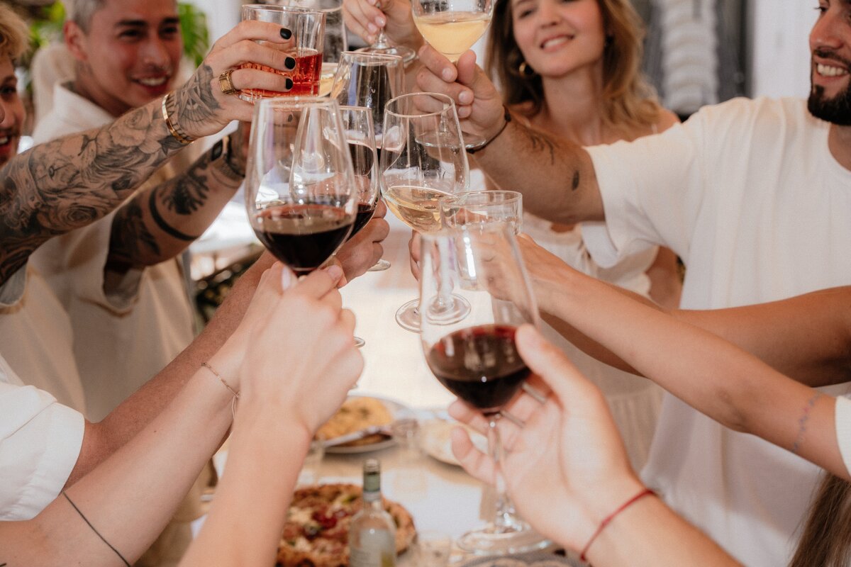 A group of people are toasting with wine glasses