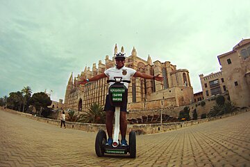 man on segway infront of palma cathedral