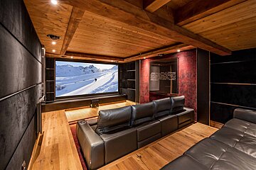A home theater with a couch and a large screen