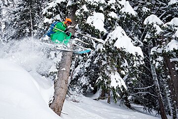 a skier jumpin through powder