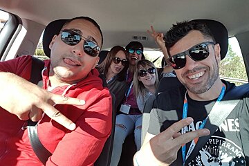 A group of people in a car with one wearing a shirt that says pipirana