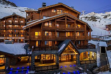 A large wooden building with the word chalet on it