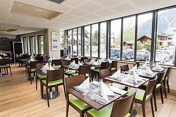 A restaurant with a lot of tables and chairs