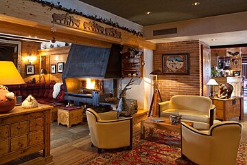 A living room with a fireplace and a couch and chairs