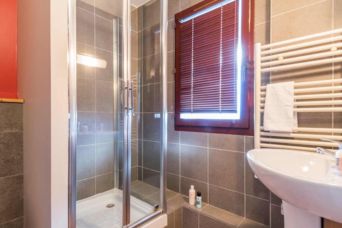A bathroom with a sink and a walk in shower
