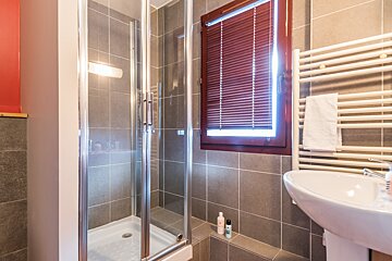 A bathroom with a sink and a walk in shower