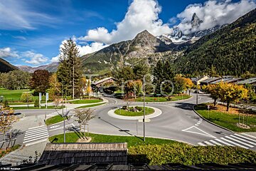 An aerial view of a roundabout with a mountain in the background
