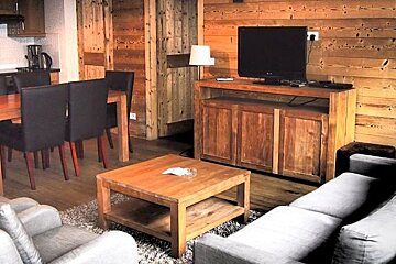 A living room with a couch a table and a television
