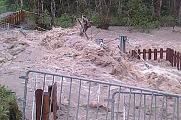 a bridge near Morzine being washed away