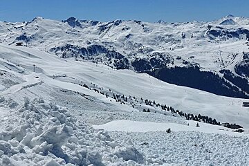 Sunny April ski day looking over to the pistes in Meribel