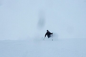 a man skiing off piste