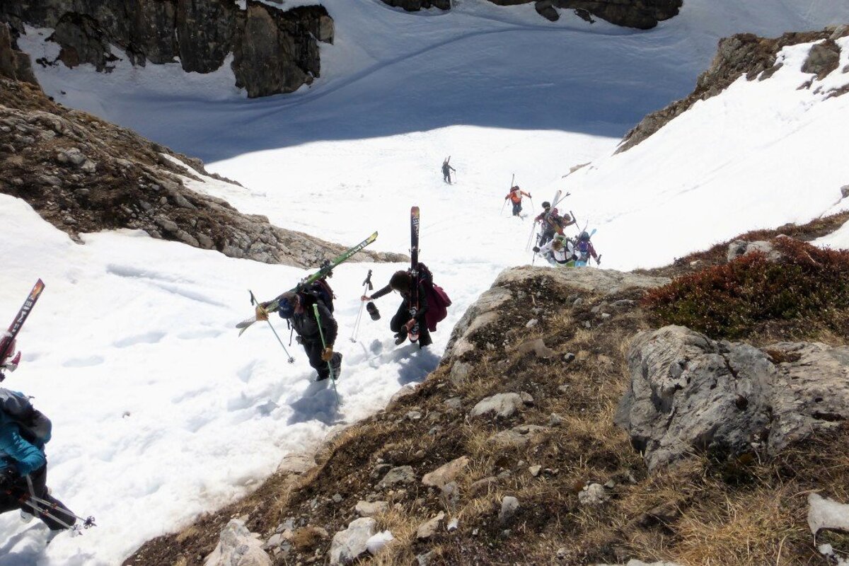 skiers hiking up out of a gorge