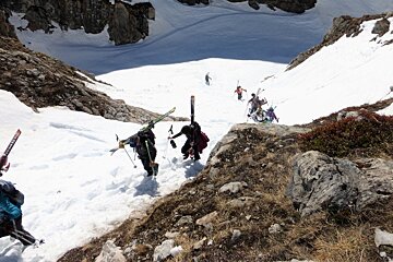 skiers hiking up out of a gorge