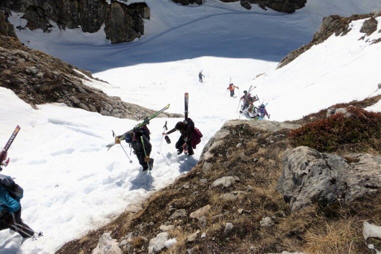 skiers hiking up out of a gorge