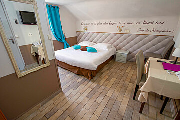 A hotel room with a sign on the wall that says guy de maupassant