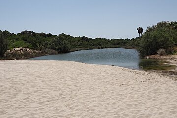 a small river behind a beach in mallorca