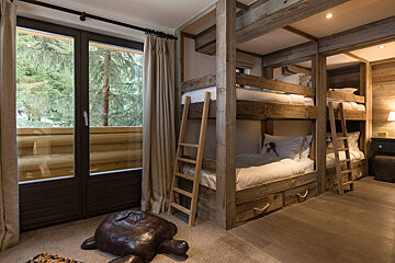 A room with bunk beds and a turtle on the floor