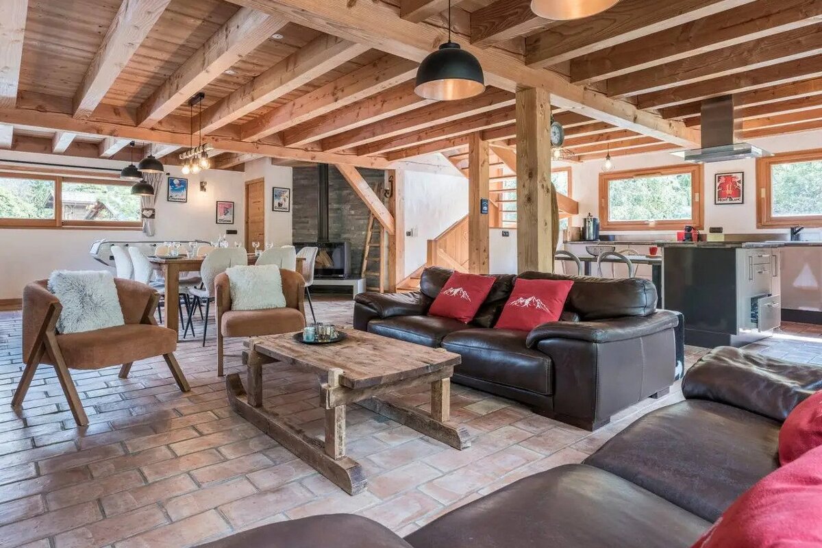 A living room with a couch and chairs and a coffee table