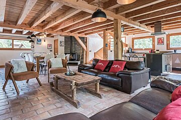 A living room with a couch and chairs and a coffee table