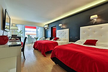 A hotel room with two beds and a desk