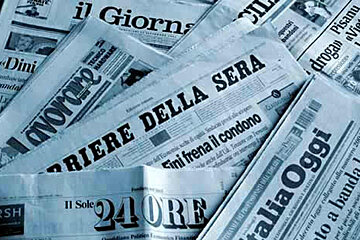 A pile of newspapers including il giornale and il sole 24 ore