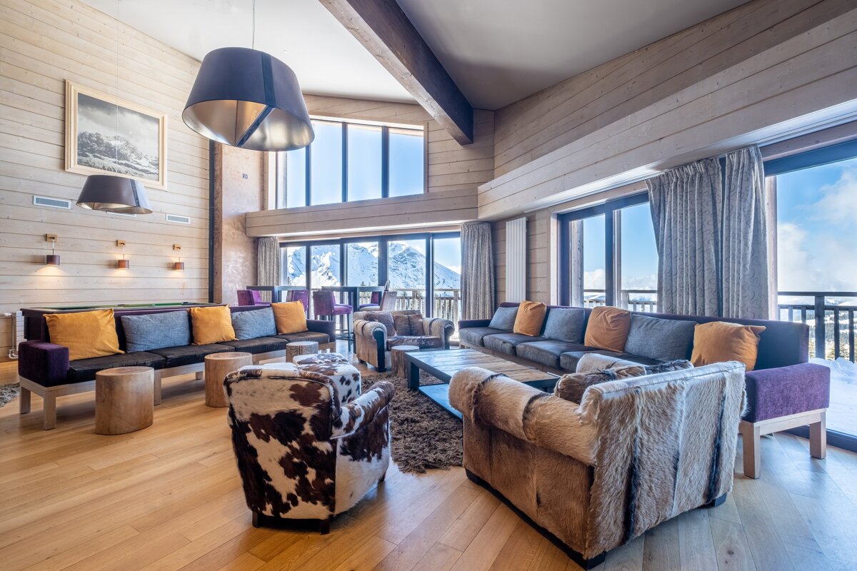 A living room with a lot of furniture and a large window