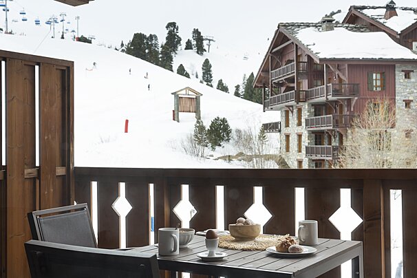 A balcony with a view of a snowy mountain