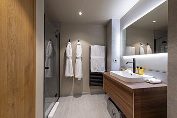A bathroom with a sink and a large mirror
