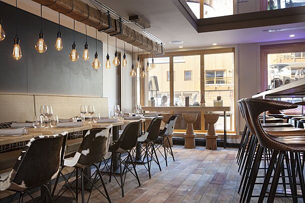 A restaurant with a lot of tables and chairs