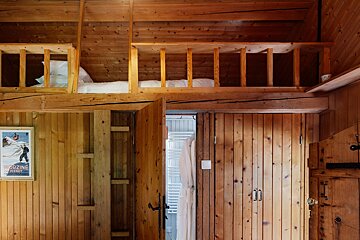 A wooden room with a poster on the wall that says