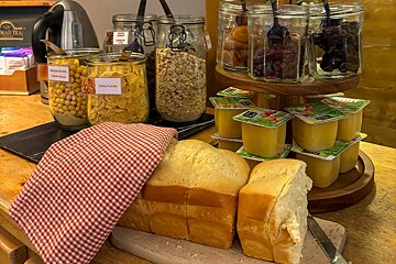 A display of food including a jar of cornflakes