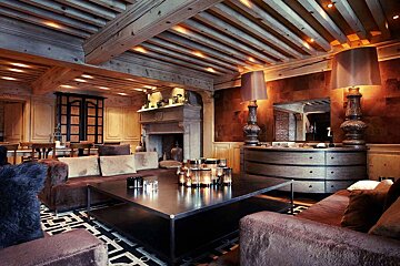 A living room with a couch and a table with candles on it