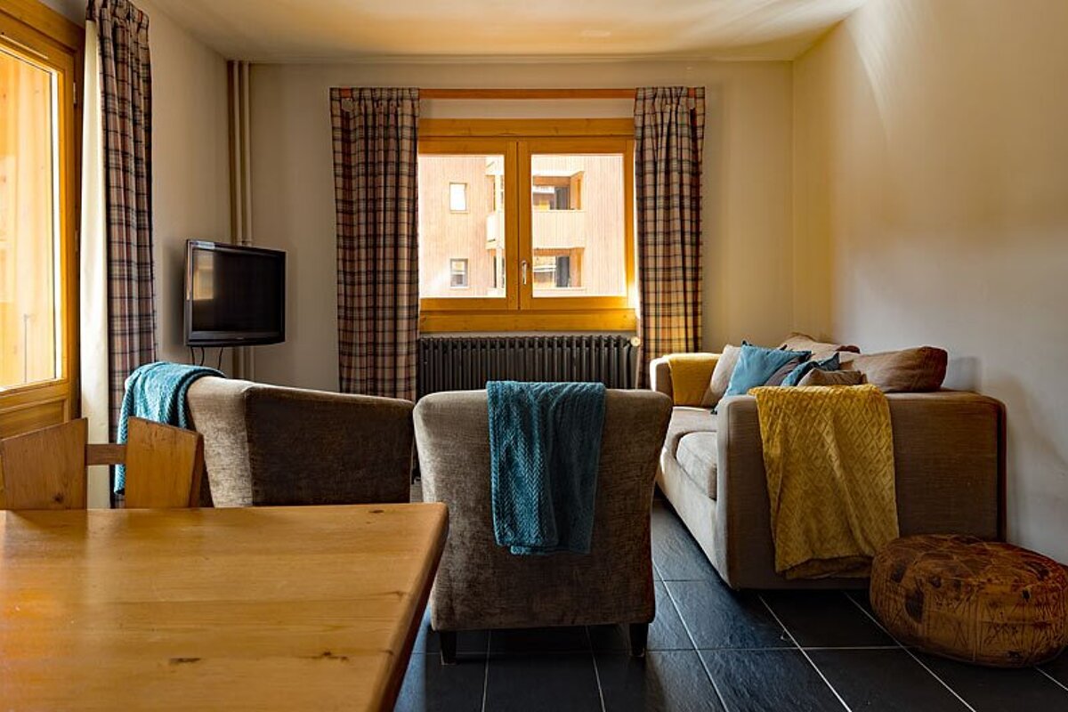 A living room with a couch and two chairs