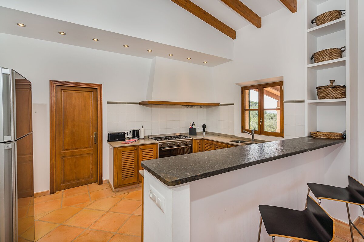 A kitchen with a stove top oven and a sink