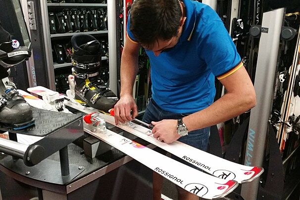 a man fixing skis