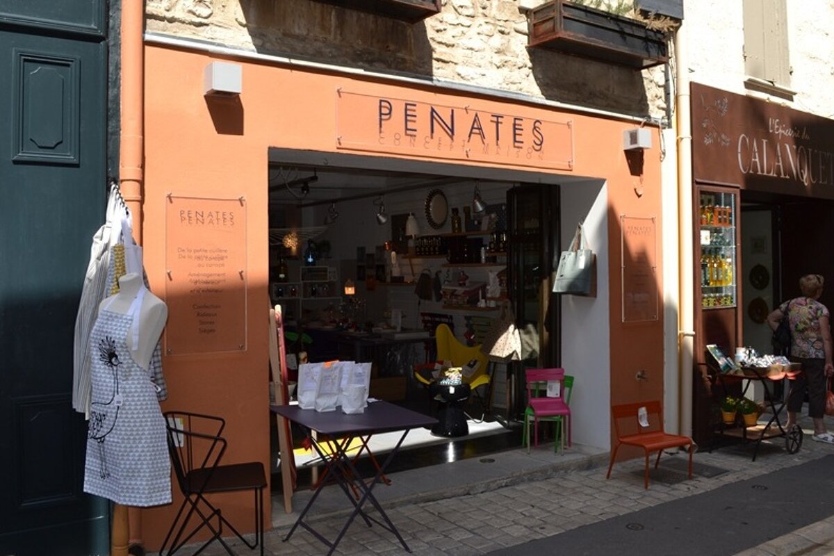 Image of some shop fronts with penates in the centre, orange shop front with a homeware display out the front