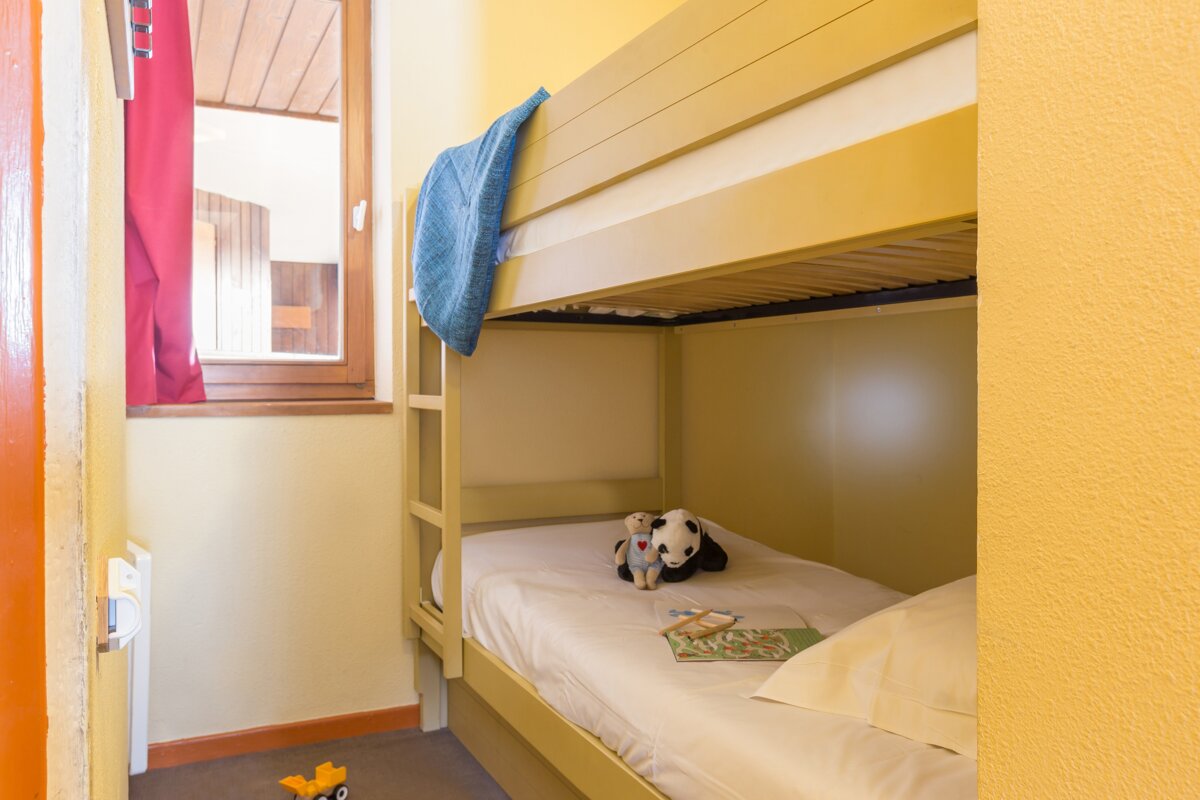 A bunk bed with a stuffed panda on it