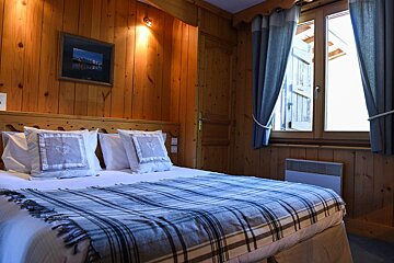 A hotel room with a large bed