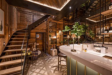 A kitchen with a bar and a staircase with a sign that says ' a ' on it