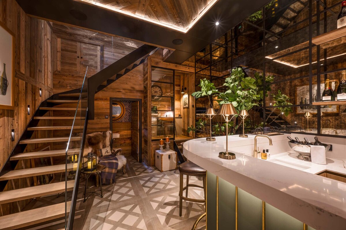 A kitchen with a bar and a staircase with a sign that says ' a ' on it