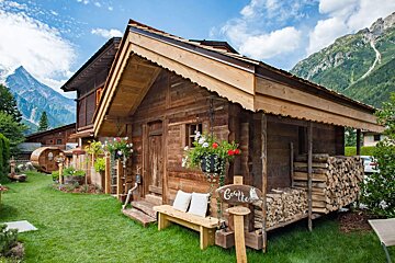 A wooden cabin with a sign that says get fit