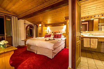 A hotel room with a bed and a bathroom