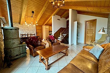 A living room with a couch and two chairs