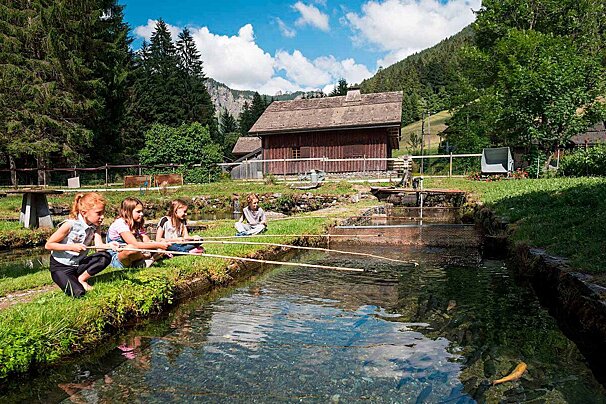 children fishing at the trout farm in Morzine