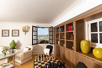 A living room with a chess board and chairs