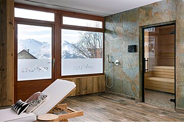 A room with a chair and a window with the word app on it