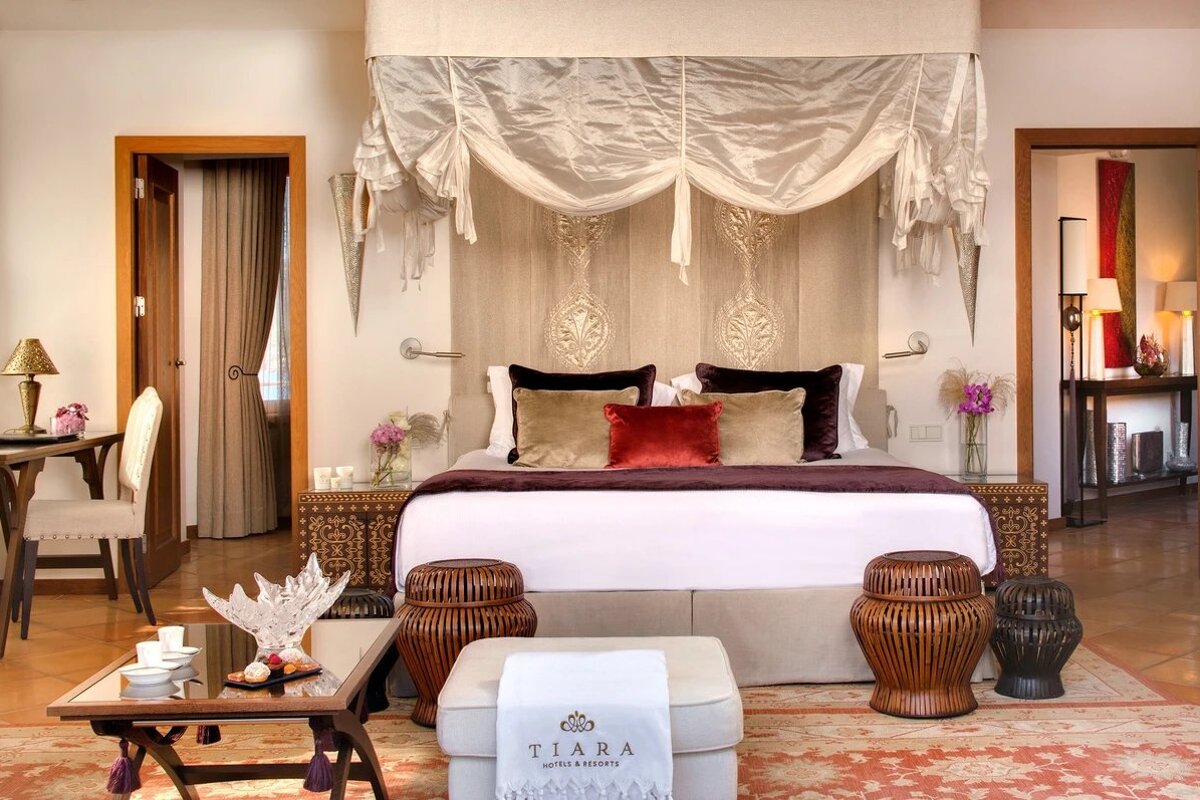 A bedroom with a canopy bed and a towel that says tiara