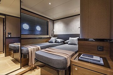 A bedroom with two twin beds and a mirror