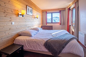 A bedroom with a bed and a book on it