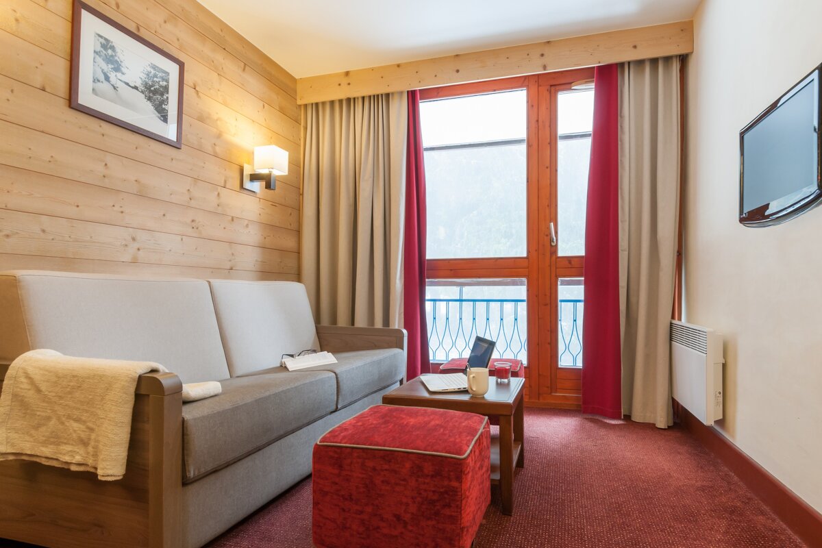 A living room with a couch and a television